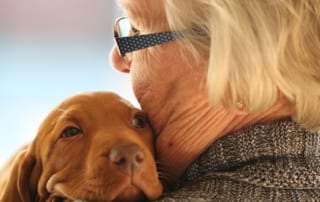 older woman with puppy