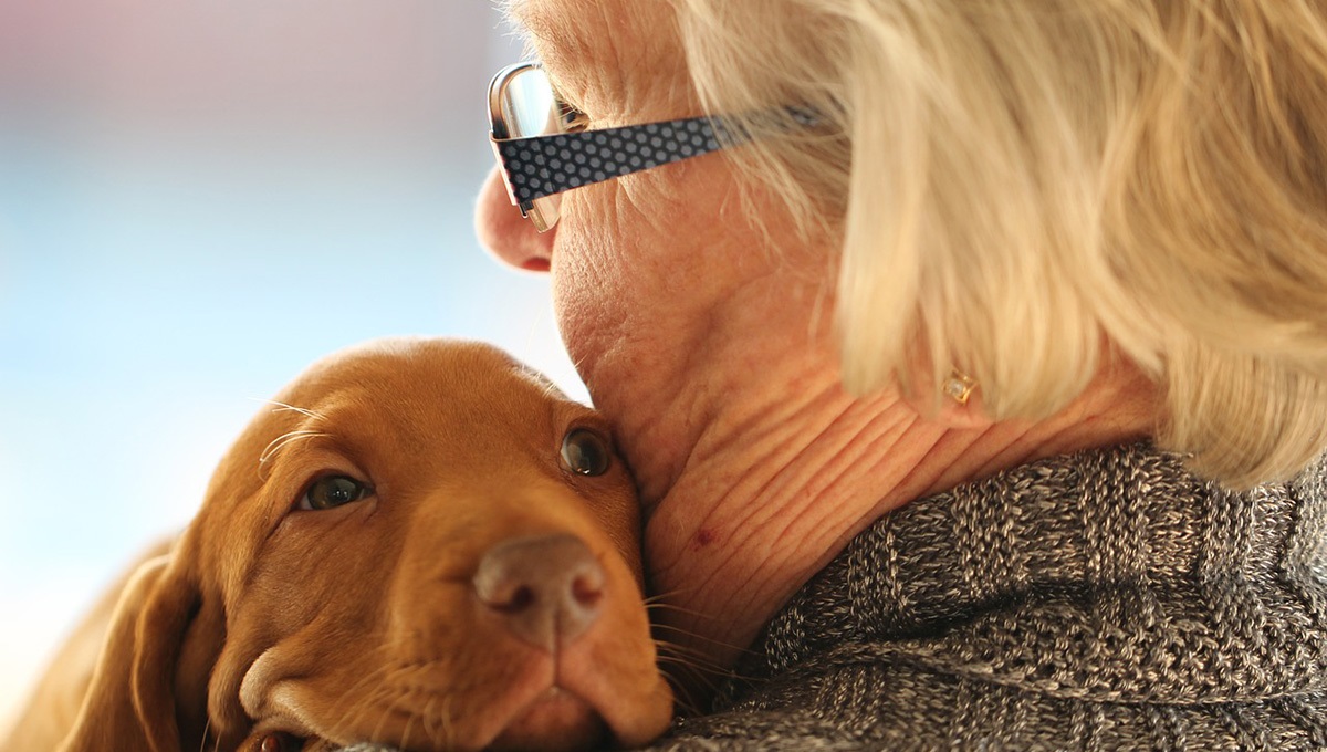 older woman with puppy