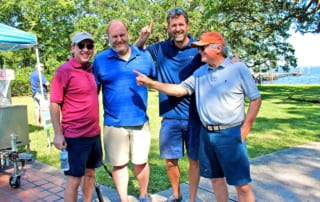 Steve Pajcic right points at Thomas Lloyd a prior year hole-in-one challenge winner. With them are Walt Nicholson and his brother Marvin who is Steve’s son-in-law.