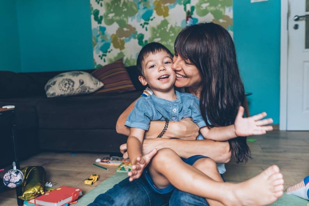 Woman and boy embracing.