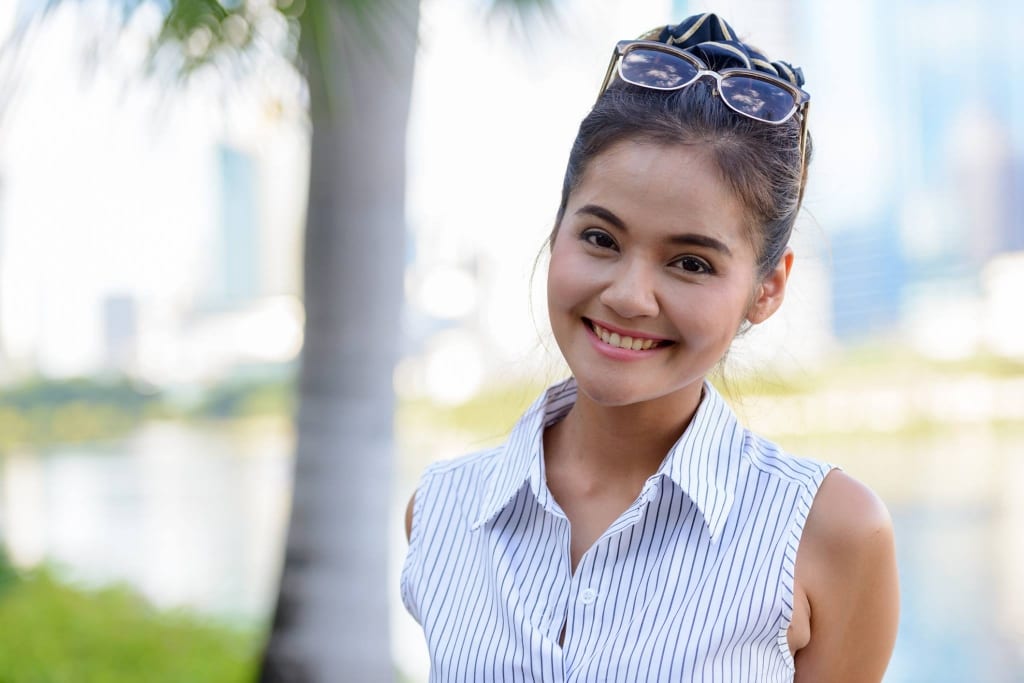 Woman outside smiling. 