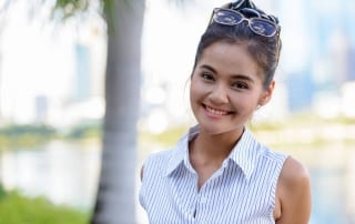 Woman outside smiling.