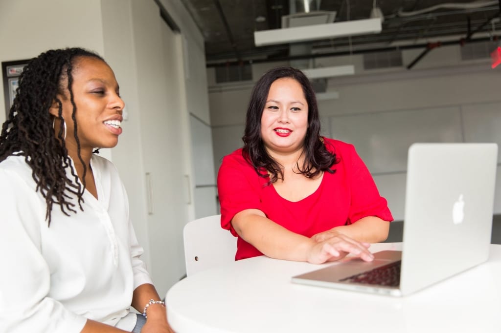 Two women looking at a computer