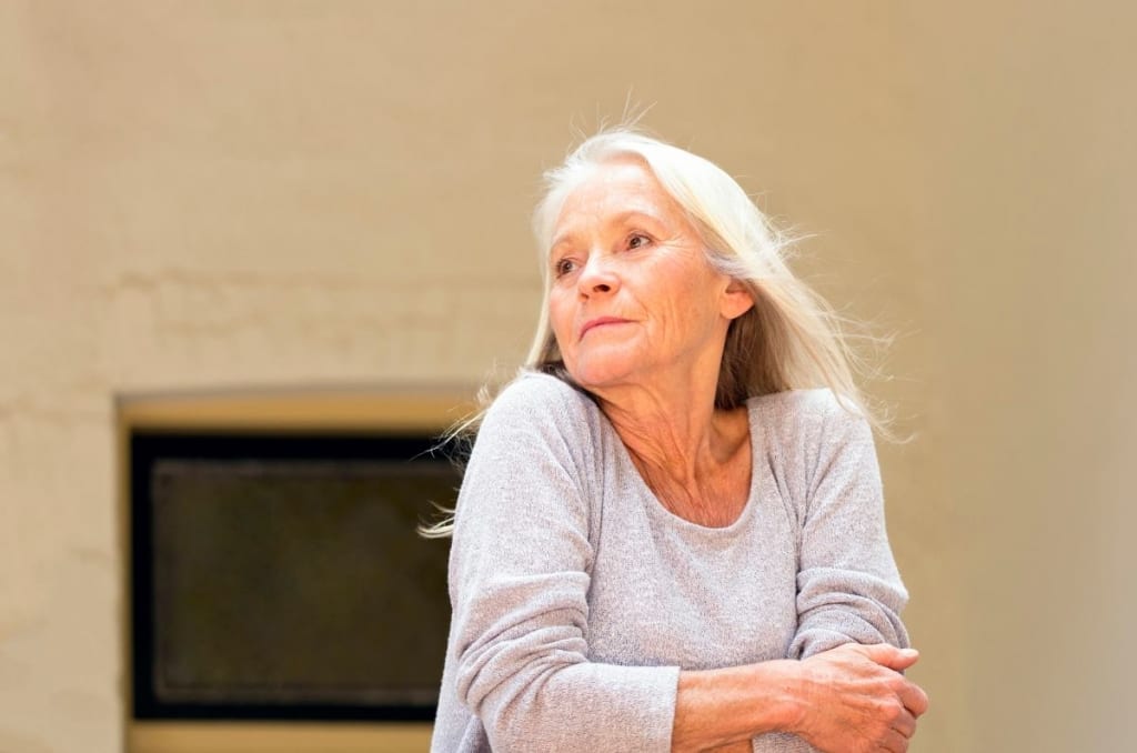 Elderly woman standing outside