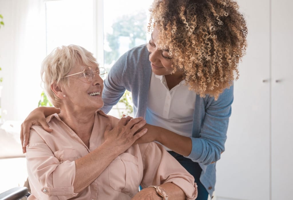 Elderly woman with aide